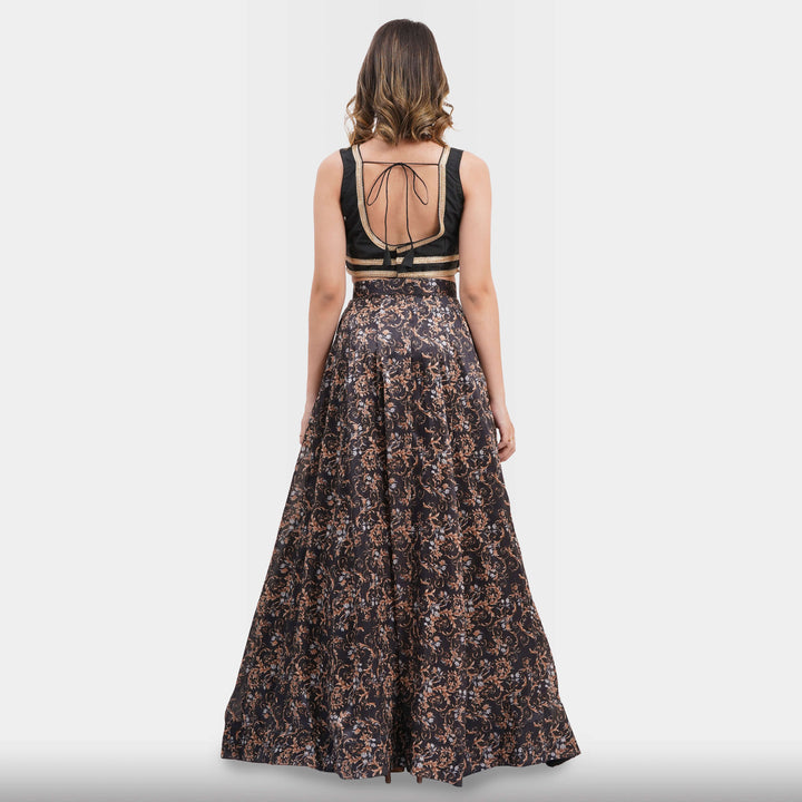 Woman wearing a floral dress with a backless top on a light gray background