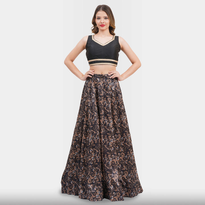 Woman wearing a black top and floral skirt on a white background