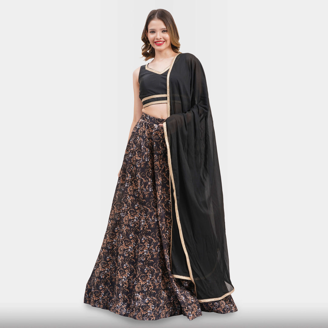 Woman wearing a floral lehenga with a black dupatta on a white background
