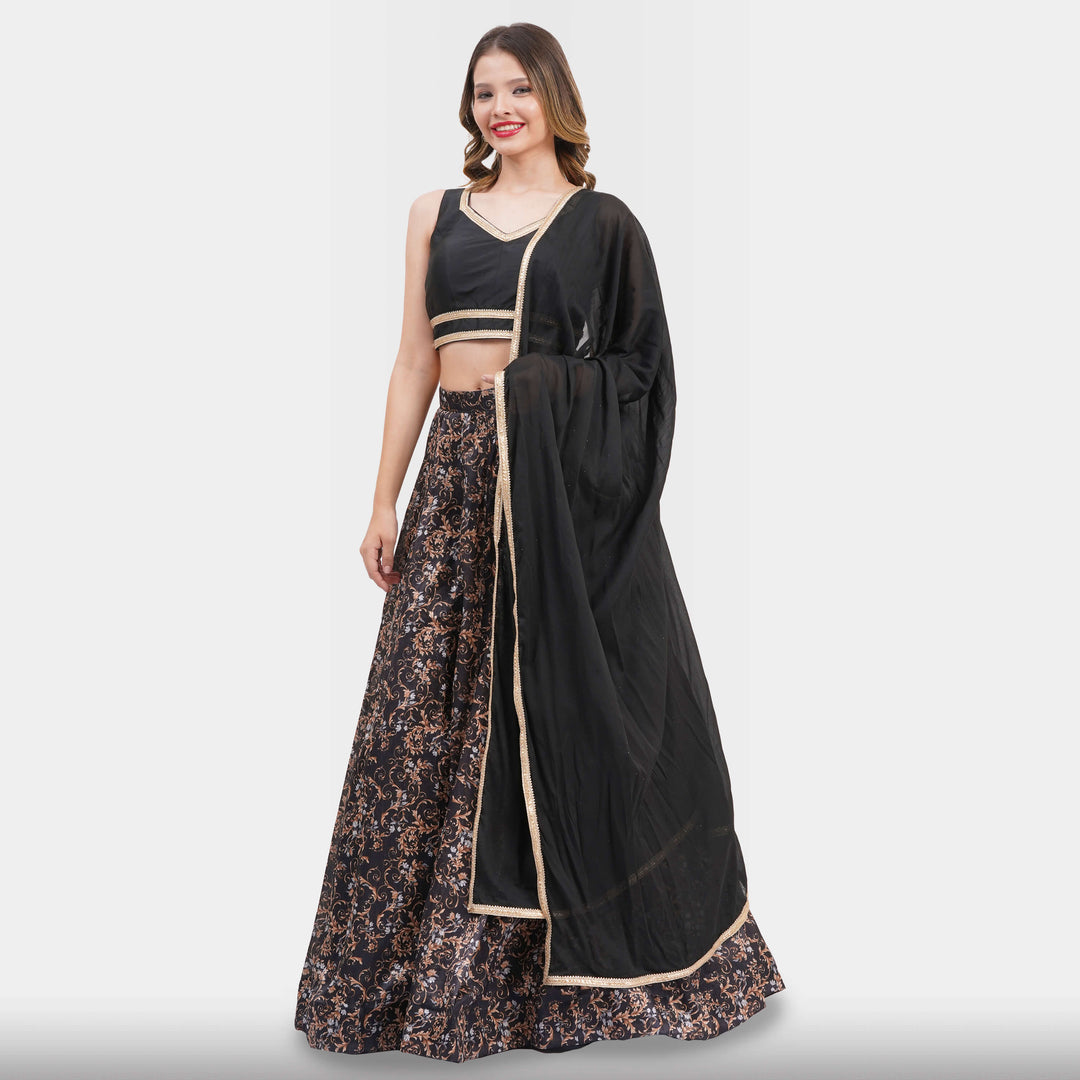 Woman wearing a black and floral dress with a matching dupatta on a white background