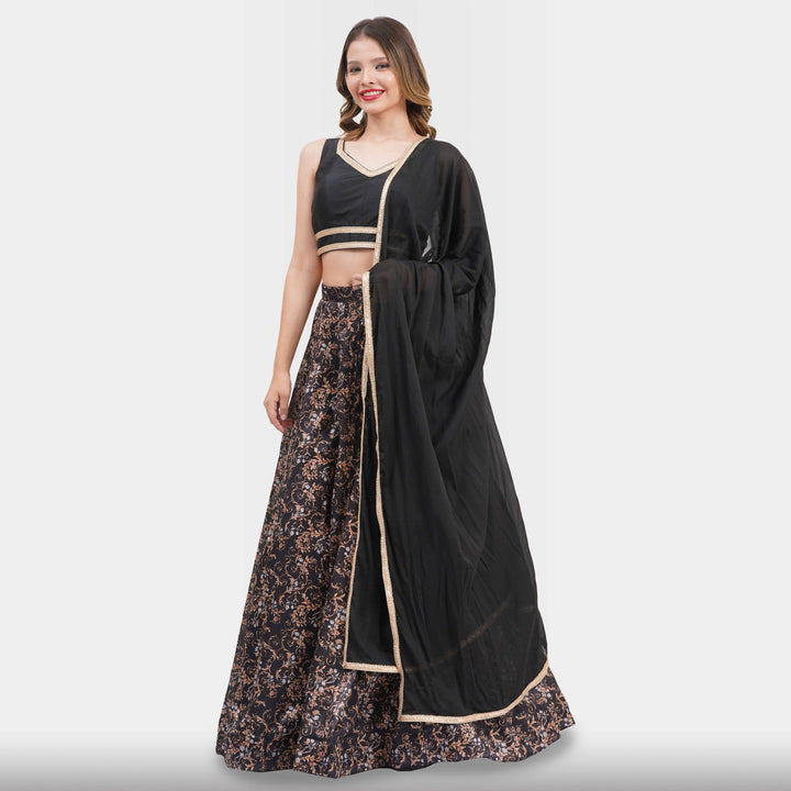 Woman wearing a black and floral dress with a matching dupatta on a white background